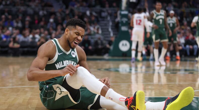 Milwaukee Bucks' Giannis Antetokounmpo reacts after suffering an injury during the first half an NBA basketball game against the Detroit Pistons, Wednesday, Dec. 3, 2025, in Milwaukee. (AP Photo/Kylie Bridenhagen)