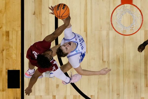 Alabama forward Mouhamed Dioubate (10) blocks a shot attempt by Duke forward Cooper Flagg (2) during the second half of an Elite Eight round NCAA college basketball tournament game, Saturday, March 29, 2025, in Newark, N.J. (AP Photo/Julia Demaree Nikhinson)
