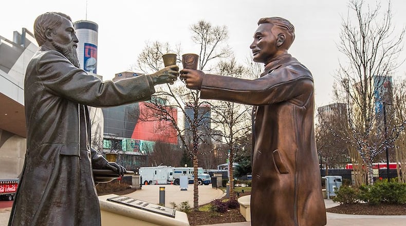 A statue of Pepsi founder Caleb Bradham, right, was delivered to the World of Coca-Cola on Wednesday and placed in front of the statue of Coca-Cola founder John Pemberton, left, as part of a promotional “cola truce” during Super Bowl week. Pepsi is an official sponsor of the Super Bowl and has placed highly visible advertising across downtown Atlanta. (Pepsi)