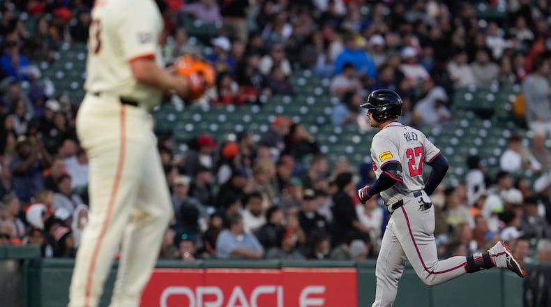 Atlanta Braves' Austin Riley, right, runs the bases after hitting a solo home run against San Francisco Giants pitcher Erik Miller, foreground, during the fifth inning of a baseball game, Wednesday, Aug. 14, 2024, in San Francisco. (AP Photo/Godofredo A. Vásquez)
