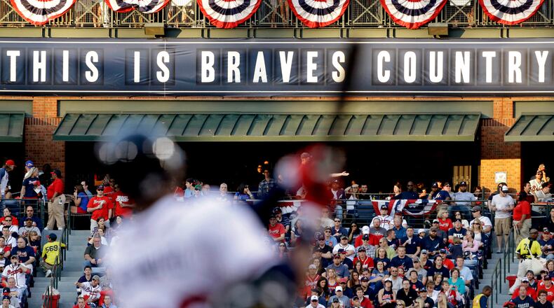 In this April 1, 2013 file photo, fans watch from the outfield as Atlanta Braves' Jason Heyward swings at a pitch in the first inning of an opening day baseball game against the Philadelphia Phillies, in Atlanta. The Atlanta Braves are leaving Turner Field and moving into a new 42,000-seat, $672 million stadium complex in Cobb County in 2017.