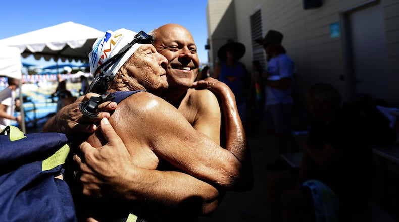 Master swimmers Maurine Kornfeld, 97, left, greets her pal Errol Graham, right, with a big hug during the USMS Spring National Championship at Kino Aquatic Center in Mesa, Arizona, in April. Maurine routinely swims at several pools in the Los Angeles area and she knows Errol from the West Hollywood Aquatics pool. Francine Orr/Los Angeles Times/TNS