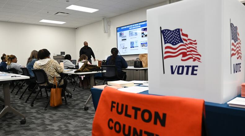 Poll workers participate Wednesday in an early voting training session at Fulton County's election hub in Fairburn. (Hyosub Shin / AJC)