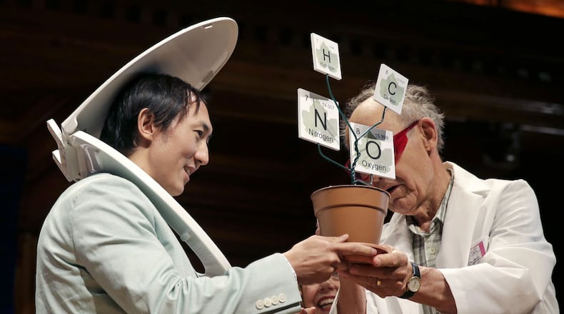 While wearing a toilet seat on his head, David Hu accepts the Physics Prize, for his research on the principle that mammals empty their bladders of urine in about 21 seconds, from Dudley Herschbach, right, the 1986 Nobel Laureate in Chemistry, while being honored during a performance at the Ig Nobel Prize ceremony at Harvard University, in Cambridge, Mass., Thursday, Sept. 17, 2015.
