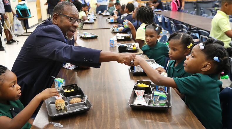 DeKalb school Superintendent Steve Green gives 6-year-old kindergarten student Lanyah Bailey a fist bump during the first day of school at last year.  Milestones test results were just released, letting schools know how they are doing in key educational issues. Curtis Compton/ccompton@ajc.com