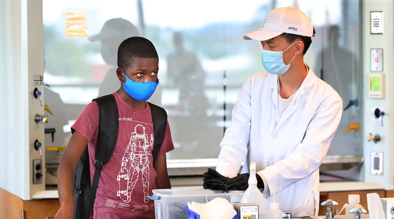 Georgia Tech student Caleb Anderson (left) gets acclimated to his chemical principles 2 lab with the help of lab assistant Brian Cheng in the G. Wayne Clough Undergraduate Learning Commons at Georgia Tech on Wednesday, August 25, 2021, in Atlanta. The 13-year-old Anderson has become the youngest student on Georgia Tech's campus. (Curtis Compton / Curtis.Compton@ajc.com)