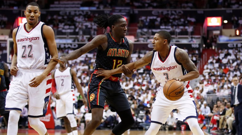 Washington Wizards guard Bradley Beal (3) is guarded by Atlanta Hawks forward Taurean Prince (12) during the first half in Game 1 of a first-round NBA basketball playoff series, in Washington, Sunday, April 16, 2017. (AP Photo/Manuel Balce Ceneta)