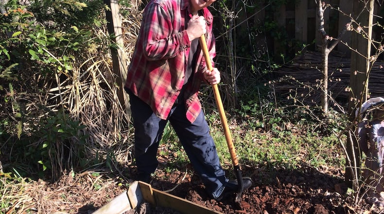 Phillip DePoy, playwright, author and musical director of the new production at the Alliance Theatre, “Edward Foote,” plants 500 tulip bulbs every fall, with the help of his wife, Lee Nowell. He took time out from writing recently to dig up some new beds in his garden. Photo by Bo Emerson.