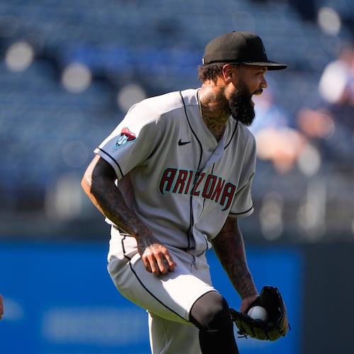 Arizona Diamondbacks' Justin Martinez, left, and Dennis Santana celebrate after their baseball game against the Kansas City Royals, Monday, Sept. 7, 2026, in Kansas City, Mo. (AP Photo/Charlie Riedel)