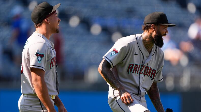 Arizona Diamondbacks' Justin Martinez, left, and Dennis Santana celebrate after their baseball game against the Kansas City Royals, Monday, Sept. 7, 2026, in Kansas City, Mo. (AP Photo/Charlie Riedel)
