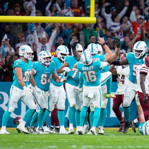 Miami Dolphins players celebrate with place kicker Riley Patterson (47) after his kicked a field goal during overtime to win an NFL football game between the Washington Commanders and the Miami Dolphins in Madrid, Spain, Sunday, Nov. 16, 2025. (AP Photo/Manu Fernandez)