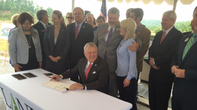 Gov. Nathan Deal signs the state budget in May 2016 at the new campus of Lanier Technical College, located near his hometown of Gainesville. The state borrowed more than $130 million to build new facilities for the campus, which Deal moved from one end of Hall County to the other.