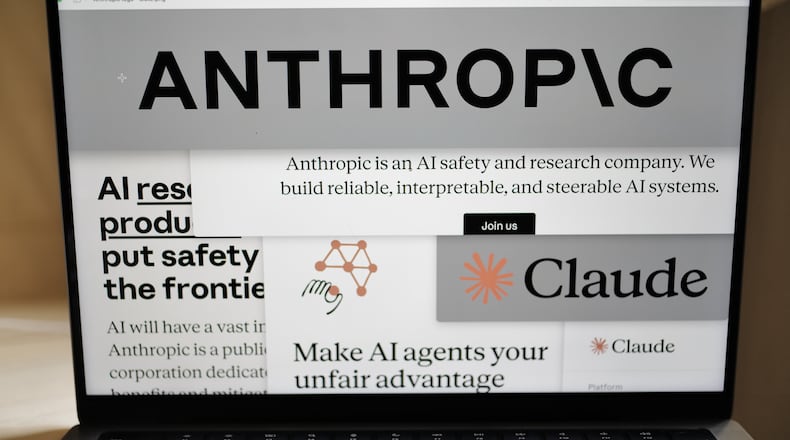 FILE - Pages from the Anthropic website and the company's logos are displayed on a computer screen in New York, Feb. 26, 2026. (AP Photo/Patrick Sison, File)