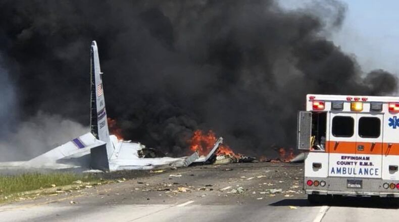 Flames and smoke rise from an Air National Guard WC-130 plane after it crashed near Savannah, Ga., Wednesday, May 2, 2018. (James Lavine via AP)