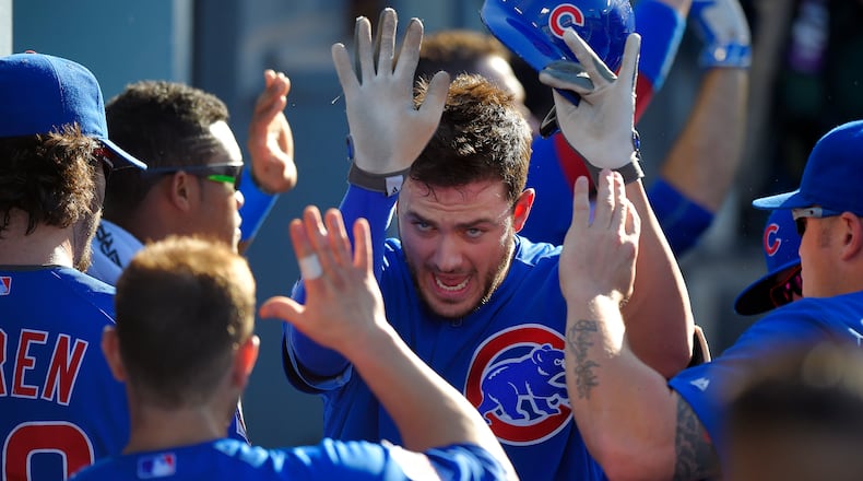 Chicago Cubs' Kris Bryant, center, is congratulated by teammates after hitting a two-run home run during the first inning of a baseball game against the Los Angeles Dodgers, Sunday, Aug. 30, 2015, in Los Angeles. (AP Photo/Mark J. Terrill)