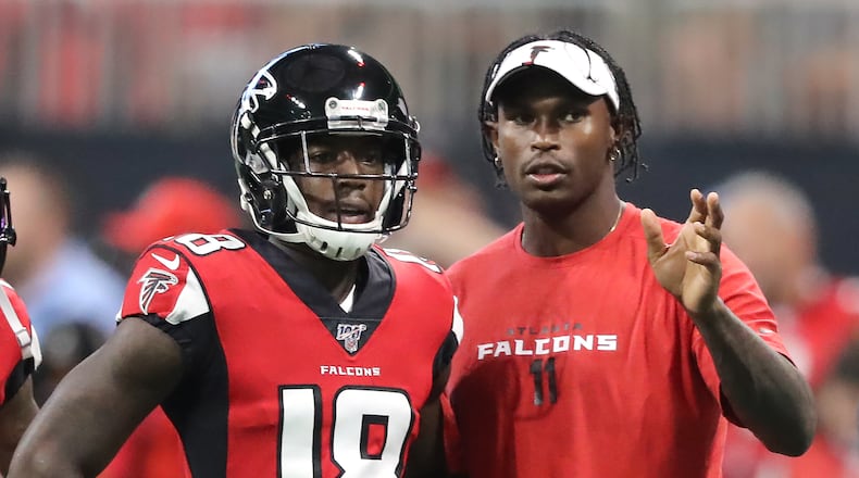 Falcons wide receiver Julio Jones, who is not playing in the game, gives wide receiver Calvin Ridley some pointers before he runs a route as the team prepares to play the New York Jets in a NFL preseason football game on Thursday, August 15, 2019, in Atlanta. Curtis Compton/ccompton@ajc.com