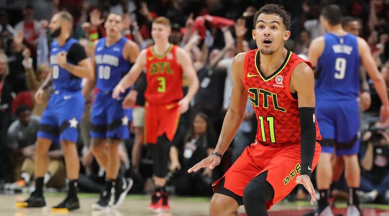 Hawks guard Trae Yound reacts to hitting a three pointer in the final minutes of a 103-99 victory over the Orlando Magic in the home opener Saturday, Oct. 26, 2019, in Atlanta.