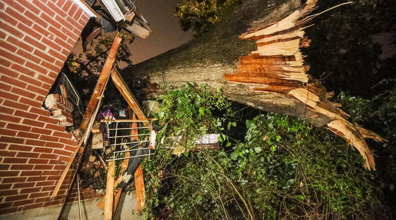 A woman was rescued after a tree fell on her North Avenue home Tuesday in Atlanta. JOHN SPINK / JSPINK@AJC.COM