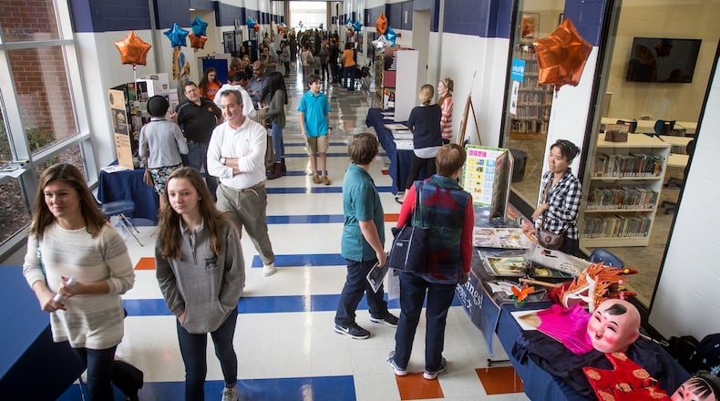 Parents and potential new students walk the halls of North Springs Charter High School during an open house in November. In a recent poll of American attitudes about schools nearly one in five Georgians said they would choose a charter school over a traditional public school if they had the choice. STEVE SCHAEFER / SPECIAL TO THE AJC