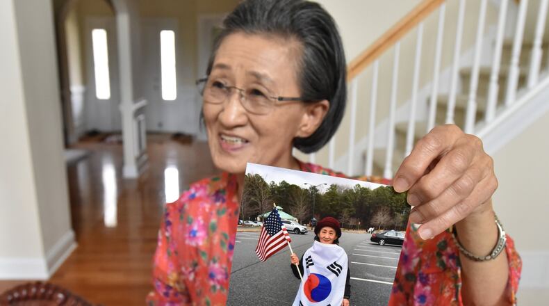 June 13, 2018 Suwanee - Eun Sung “Grace” Im, showing a photograph of herself, was just a young girl when she and her family fled North Korea during the war, riding on a crowded fishing boat that caught fire and nearly sank before landing safely below the 38th parallel. HYOSUB SHIN / HSHIN@AJC.COM