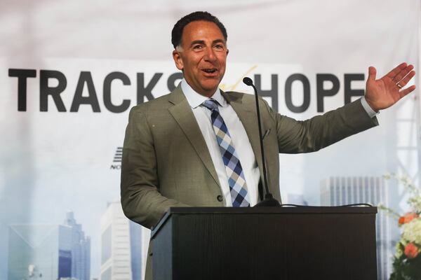 President and CEO of Norfolk Southern Mark George speaks during Tracks of Hope, an event hosted by Norfolk Southern in support of Hope Atlanta, in Forest Park, on Thursday, Nov. 13, 2025. The company has given more than $600,000 to the nonprofit fighting homelessness in Atlanta. (Abbey Cutrer/AJC)