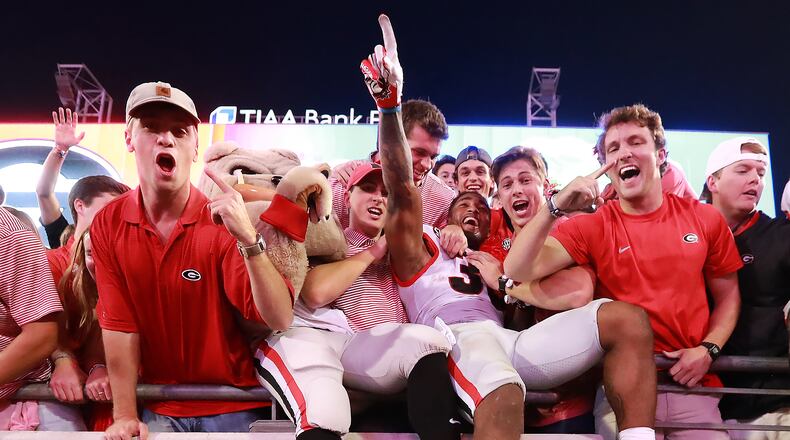 Georgia players climb into the stands to celebrate a 24-17 victory over Florida.   Curtis Compton/ccompton@ajc.com
