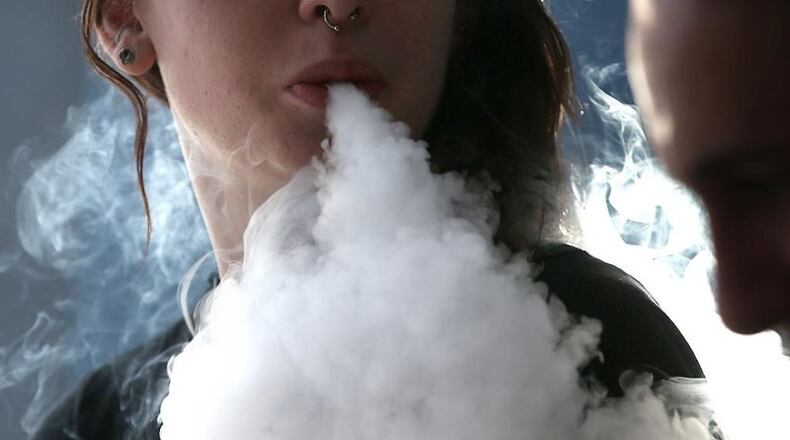 Johns Creek has approved a zoning amendment that seeks to restrict the sale of vape juice and vaping-related products in local stores. AJC FILE