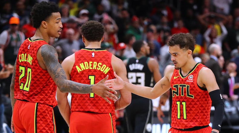 Atlanta Hawks guard Trae Young is congratulated by teammate John Collins after hitting a shot in overtime against the Milwaukee Bucks Sunday, March 31, 2019, at StateFarm Arena n Atlanta.