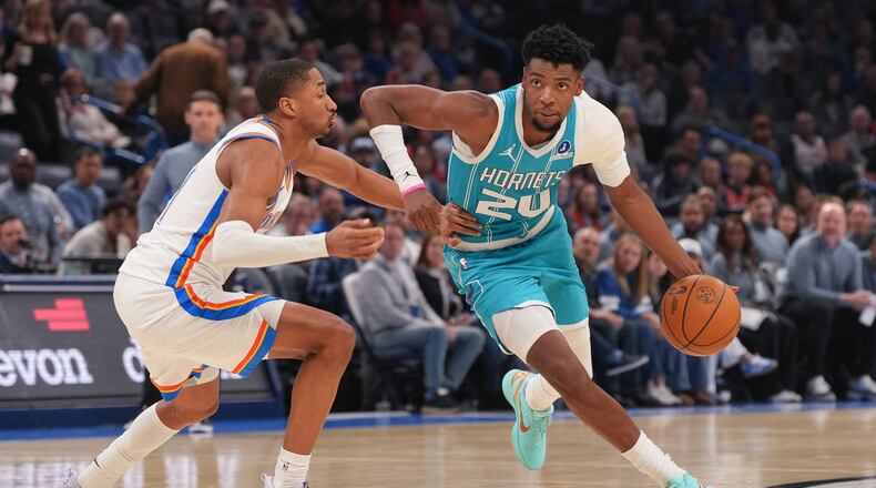 Charlotte Hornets forward Brandon Miller, right, drives past Oklahoma City Thunder guard Aaron Wiggins, left, during the second half of an NBA basketball game, Monday, Jan. 5, 2026, in Oklahoma City. (AP Photo/Kyle Phillips)