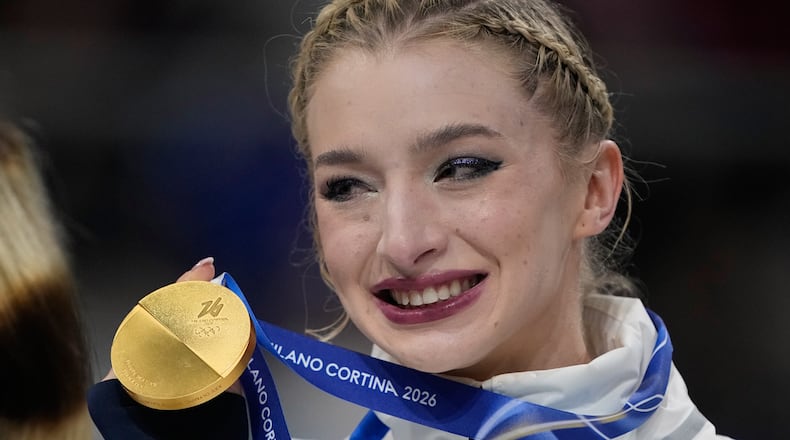 Team USA's Amber Glenn celebrates with her gold medal after the figure skating team event at the 2026 Winter Olympics, in Milan, Italy, Sunday, Feb. 8, 2026. (AP Photo/Ashley Landis)