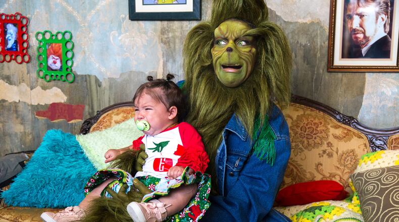 Pets can take pictures with holiday characters, including the Grinch, at the Gwinnett County Animal Shelter this weekend. The Grinch in this photo is “in residence” at Ponce City Market on weekends leading up to Christmas.
