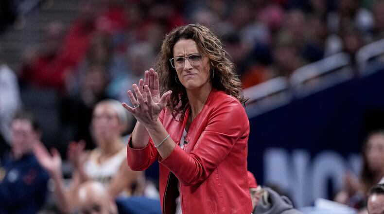 Indiana Fever head coach Stephanie White cheers as the Indiana Fever plays the New York Liberty in the first half of a WNBA basketball game in Indianapolis, Tuesday, Aug. 11, 2026. (AP Photo/Michael Conroy)