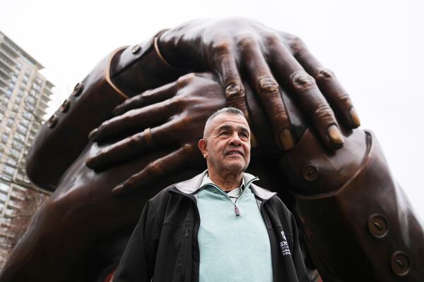 Wayne Lucas, who sixty years ago participated at the Freedom Rally on Boston Common, poses at the "The Embrace" sculpture on the common, Tuesday, April 15, 2025, in Boston. (AP Photo/Charles Krupa)