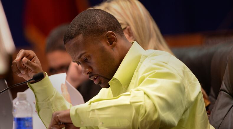 Cobb County School Board member David Morgan looks through the budget during the Cobb County School Board meeting. JOHNNY CRAWFORD / JCRAWFORD@AJC.COM