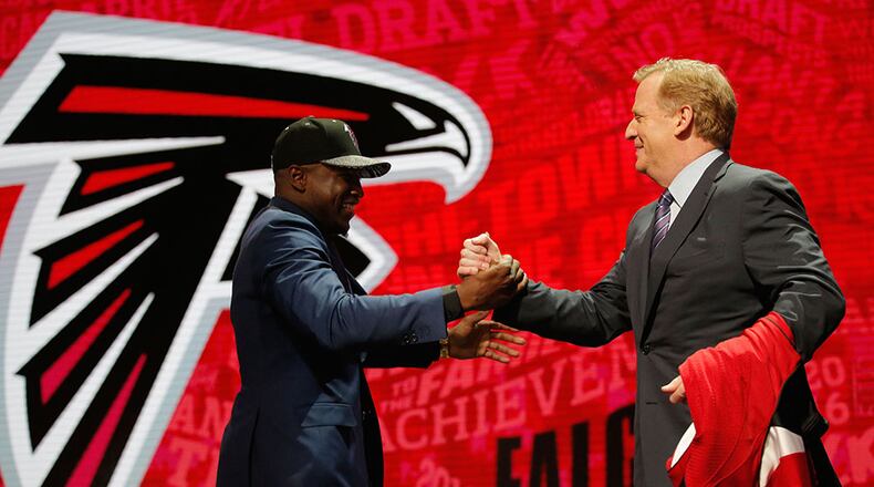 NFL Commissioner Roger Goodell greets Atlanta Falcons' top pick (17th overall) Keanu Neal with a team jersey during the first round of the 2016 NFL Draft in Chicago.