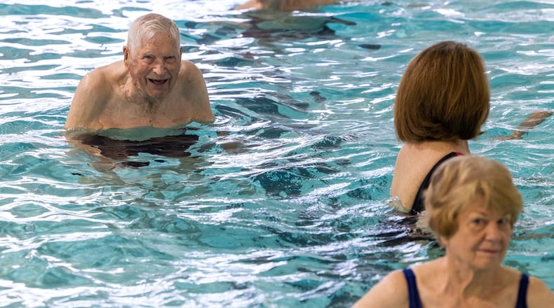 A 104-year-old WWII veteran, Charlie Duncan (upper left) does water aerobics three days a week at the Mountain View Aquatic Center in east Cobb. PHIL SKINNER FOR THE ATLANTA JOURNAL-CONSTITUTION
