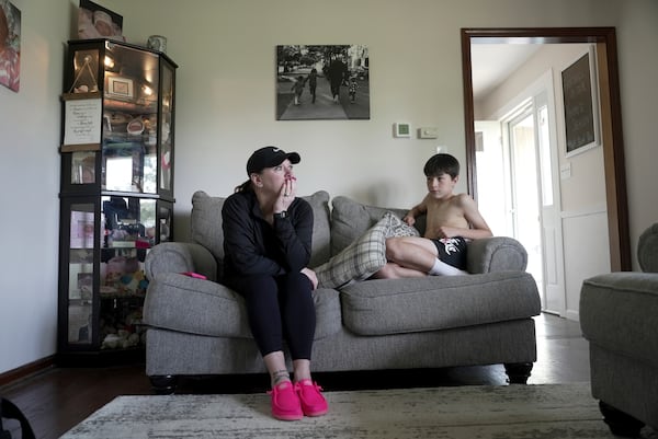 Katie Van Tornhout sits with her son, Cain, at home in Lakeville, Ind., on May 7, 2025. (AP Photo/Shelby Lum)