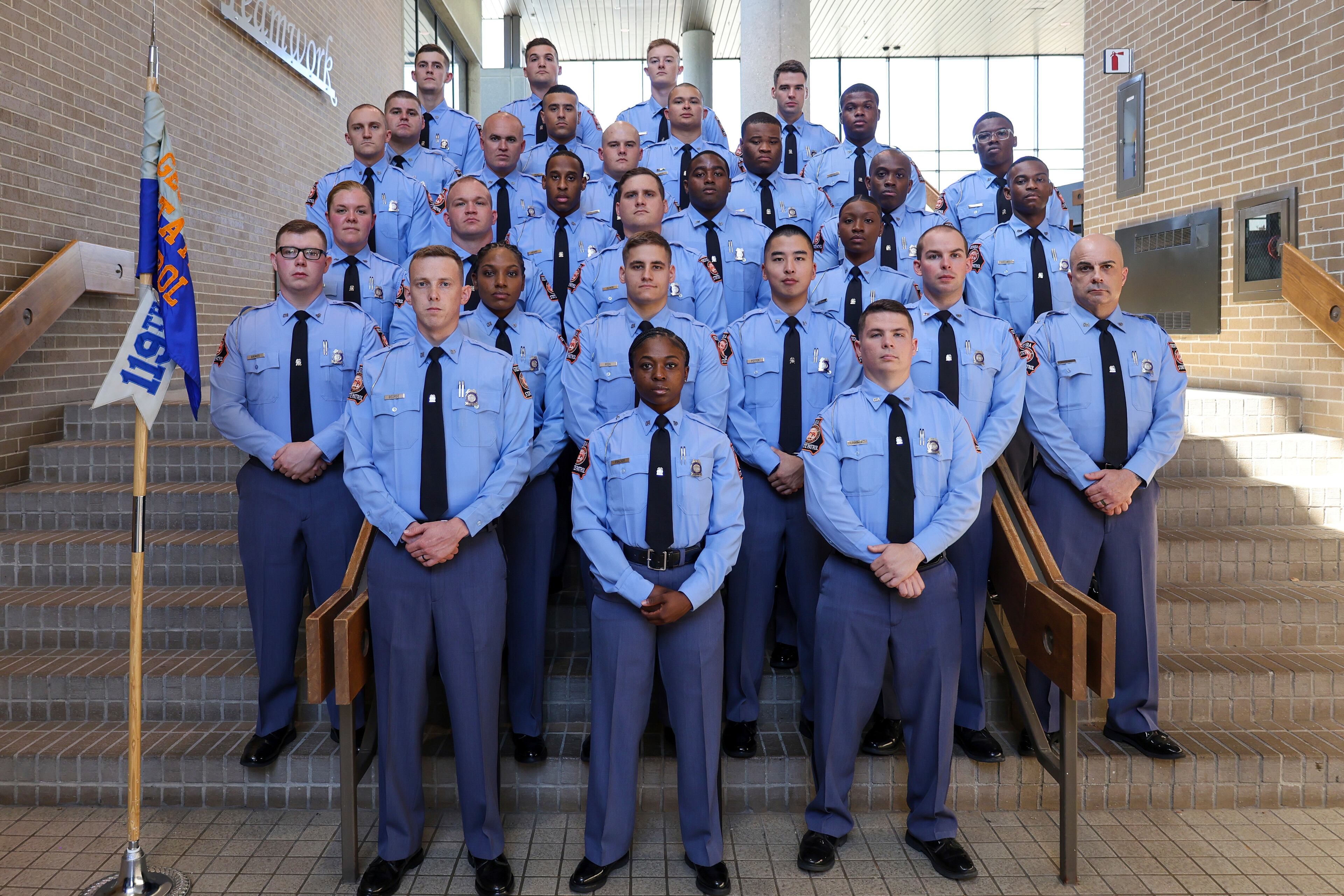 Lucy Kemp stands at the far left on the third row from the bottom as a member of a graduating class of new Georgia state troopers in Forsyth.