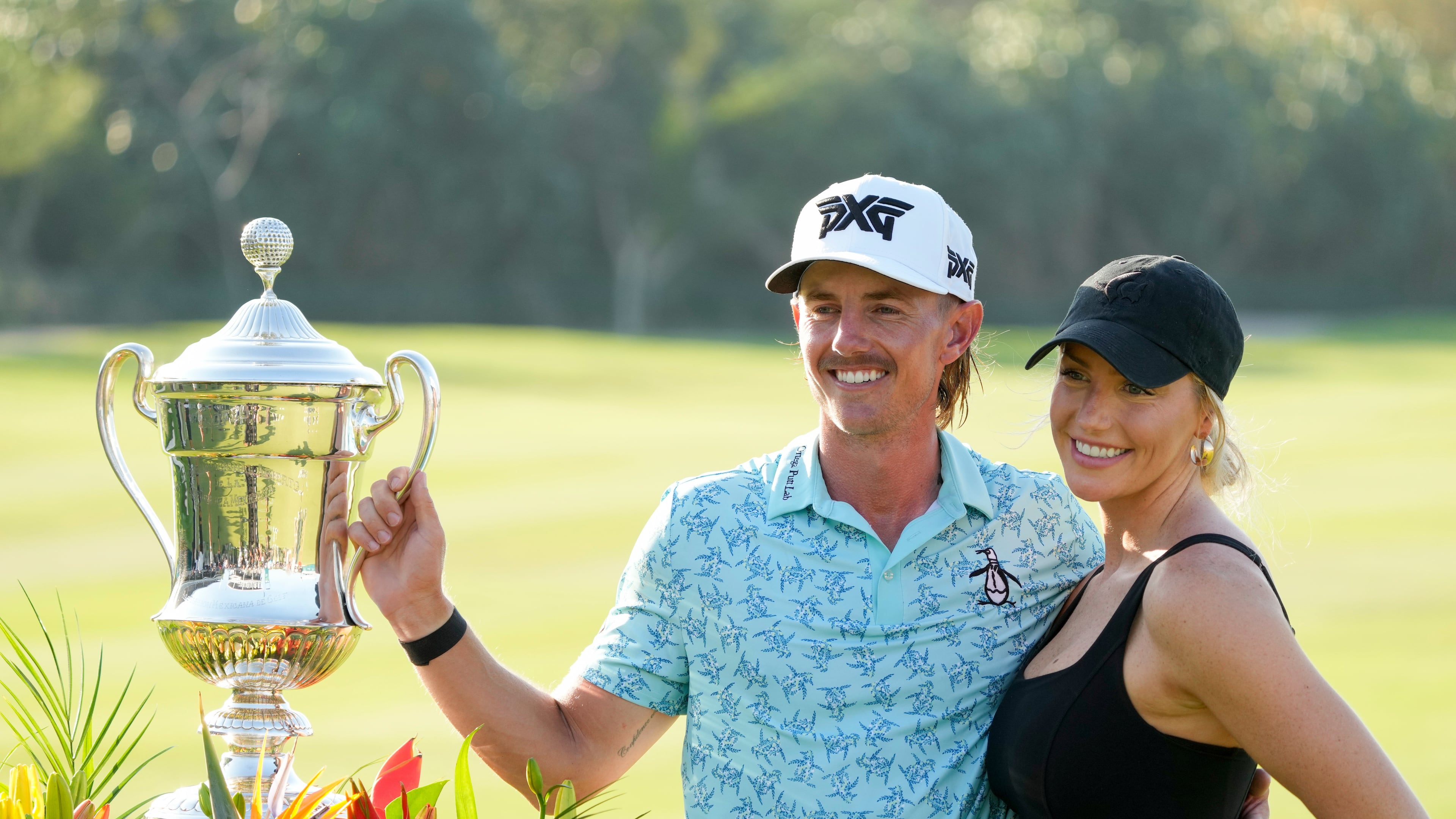 FILE - Jake Knapp, of the United States, and his girlfriend Makena White pose with his trophy during the award ceremony after winning the Mexico Open golf tournament in Puerto Vallarta, Mexico, Sunday, Feb. 25, 2024. (AP Photo/Fernando Llano, File)