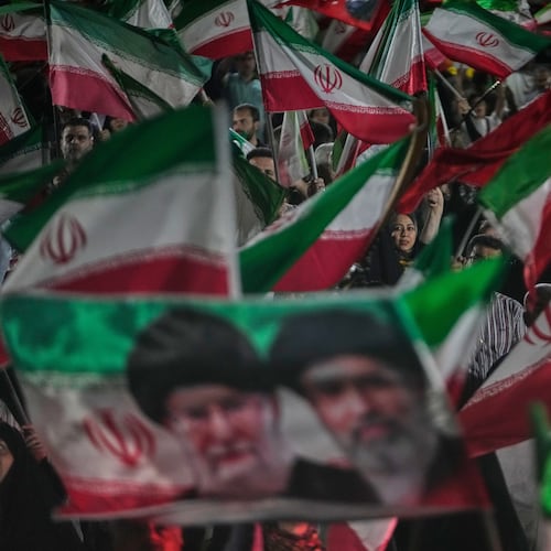 Pro-government Iranian demonstrators wave Iranian flags and a portrait of the Supreme Leader Ayatollah Mojtaba Khamenei, right, and his slain father Ayatollah Ali Khamenei in a gathering at a square in Tehran, Iran, Friday, May 29, 2026. (AP Photo/Vahid Salemi)