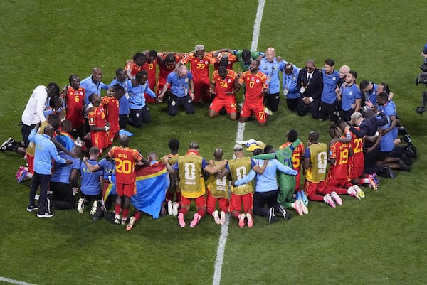 Congo players and staff pray after the World Cup Group K soccer match between DR Congo and Uzbekistan in Atlanta, Saturday, June 27, 2026. (AP Photo/Mike Stewart)