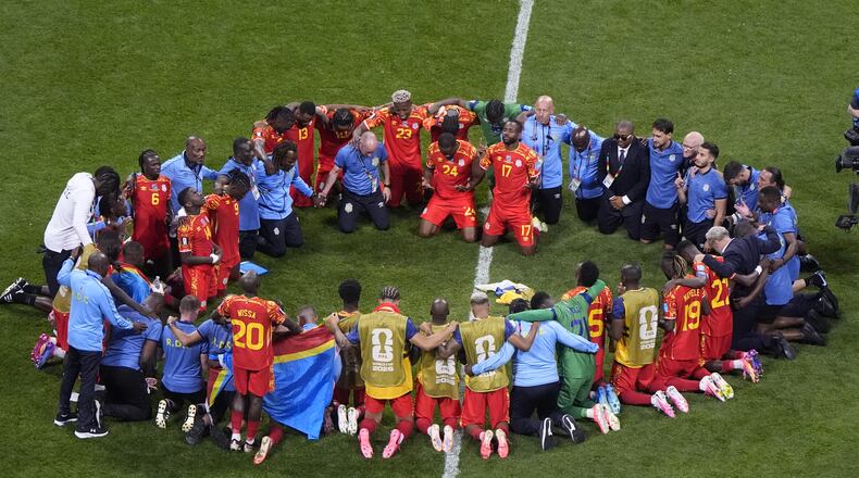 Congo players and staff pray after the World Cup Group K soccer match between DR Congo and Uzbekistan in Atlanta, Saturday, June 27, 2026. (AP Photo/Mike Stewart)