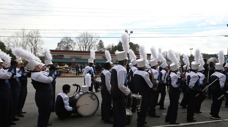 January 16, 2017, Atlanta - A bass drum player taps out and kneels for a short rest towards the conclusion to the annual MLK Day parade in Lawrenceville, Georgia, on Monday, January 16, 2017. (HENRY TAYLOR / HENRY.TAYLOR@AJC.COM)