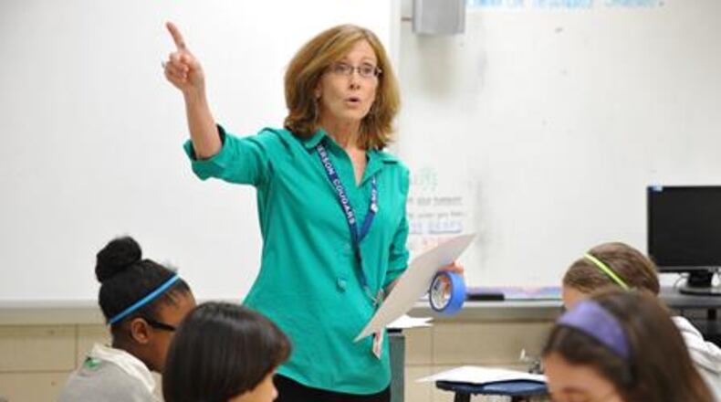 May 15, 2014 Atlanta - Paula Moore, math teacher, teaches her classs at Henderson Middle School in Atlanta on Thursday, May 15, 2014. In 2006, Georgia education officials touted the growing numbers of minority and disadvantaged students flowing into gifted classes. But an analysis by The Atlanta Journal-Constitution shows black students still lag significantly behind their white counterparts in gifted programs. And the gap is wide when it comes to poor students. HYOSUB SHIN / HSHIN@AJC.COM Georgia plans to assess teachers based on student growth, but are we clear on what growth really means? HYOSUB SHIN / HSHIN@AJC.COM