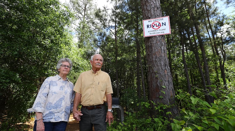 Penny and George West have anti-Rivian signs posted along their 25 acres of natural forest land surrounding their home near Madison. “Curtis Compton / Curtis.Compton@ajc.com”