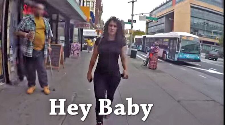 Screen grab from the Rob Bliss Creative Hollaback! video that depicts a woman walking in Manhattan, being harassed by male bystanders.