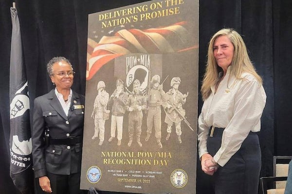 This photo provided by Jeanie Jacobs Huffman shows her, right, with Principle Deputy Director of Defense POW/MIA Accounting Agency Fern Sumpter Winbush, left, during an unveiling ceremony for the 2025 National Recognition Day poster. (Dave Huffman/Jeanie Jacobs Huffman via AP)