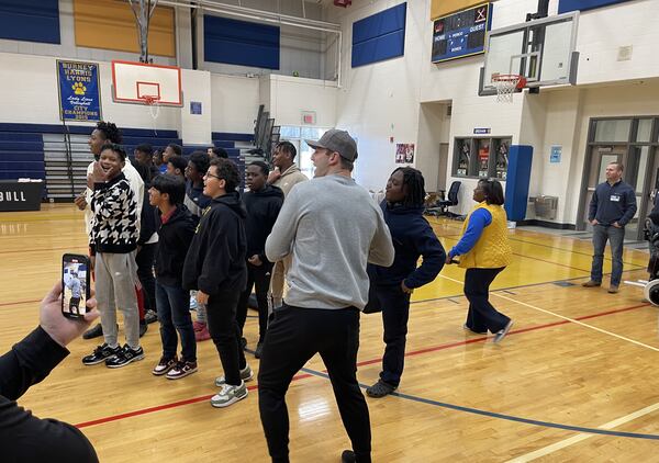 Brock Bowers prepares to throw a pass while interacting with students at Burney-Harris-Lyons Middle School in Athens Tuesday.