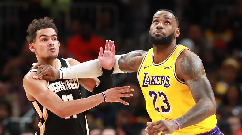 December 15, 2019 Atlanta: Los Angeles Lakers forward LeBron James pushes Atlanta Hawks guard Trae Young out of the way as he prepares to grab a jump ball during the second half in a NBA basketball game on Sunday, December 15, 2019, in Atlanta. The Lakers beat the Hawks 101-96, Curtis Compton/ccompton@ajc.com