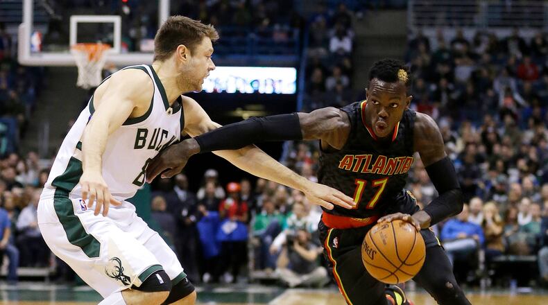 Atlanta Hawks’ Dennis Schroder (17) drives to the basket against Milwaukee Bucks’ Matthew Dellavedova during the second half of an NBA basketball game Friday, Dec. 9, 2016, in Milwaukee. The Hawks won 114-110. (AP Photo/Aaron Gash)